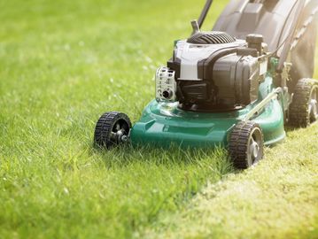 Lawn mower on green grass